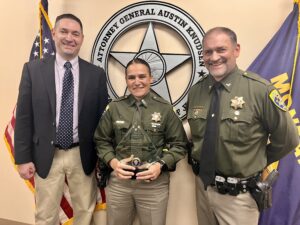 Trooper Barb Armstrong with Attorney General Austin Knudsen and MHP Colonel Steve Lavin following Wednesday's award ceremony